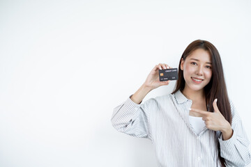 The hand of an Asian woman holding a credit card is used for online shopping and Internet payments