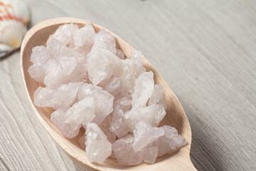 Spa nature products. Wooden spoon with white sea salt for bathroom procedures