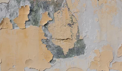 Fotobehang Verweerde muur het oppervlak van de oude muur met de verf die eraf vliegt