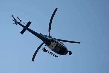 helicopter flying in the solid blue colored sky