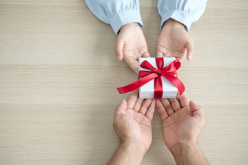 Gift box hand holding a gift box Glad to be the giver of surprise with excitement, the joy on the holidays, Christmas, birthdays, or Valentine's Day concept