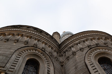 Architecture elements of old church in russian Sergeevo village with walls, windows, chimney in cloudy day