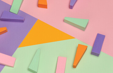 Top view of multi-colored sponges on different pastel-colored backgrounds. Abstract image