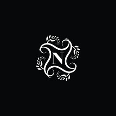 Initial Letter N Flourish circle monogram logo.