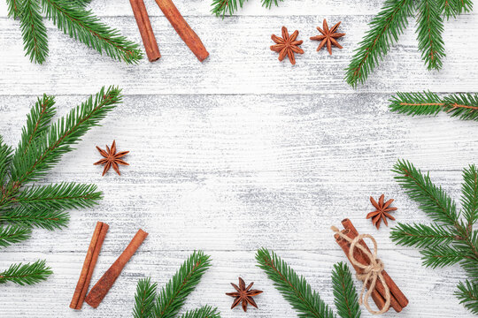 Christmas background with fir tree and spice on wooden table. Top view. Copy space for text