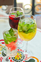 Glasses of red wine and white wine with watermelon pieces on the table. Delicious cold fruit drink served in glasses.