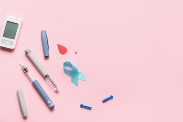 Awareness ribbon with syringes and glucometer on color background. Diabetes concept