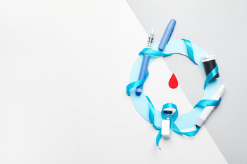 Blue ring with syringe, lancet pen and insulin on light background. Awareness concept