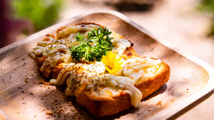 Slice of toasted white bread spread with mayonnaise decorate on top with flower and