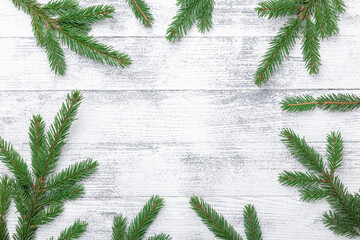 Christmas background with fir tree branch on wooden table. Eco natural frame. Top view. Copy space
