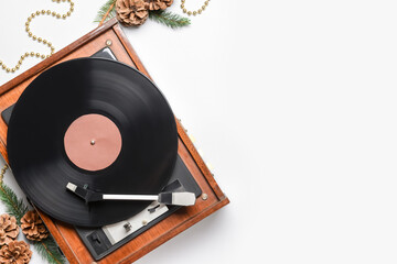 Record player and Christmas decor on light background