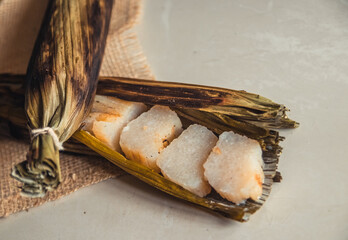 Brazilian traditional dessert. Bolo de tapioca (mane doido, pe de zumbi or pe de moleque nordestino similar to carimã, cassava cake). Brazilian cake made from tapioca flour, wrapped in banana leaves.