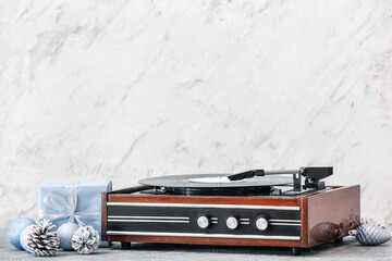 Record player and Christmas decor on table