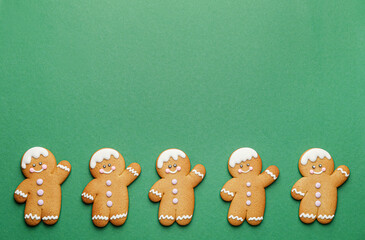 Tasty gingerbread cookies on color background