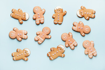 Tasty gingerbread cookies on color background