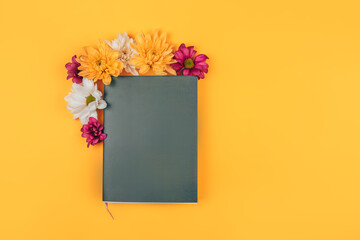Mix of different colors next to a black notebook, a gift for any occasion, a gift to your loved one on a yellow background