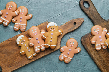 Boards and tasty gingerbread cookies on grey background