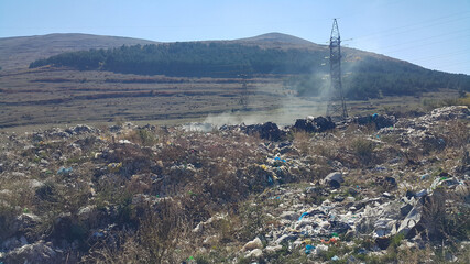 Garbage dump near the forest in nature. Social issues related to environmental protection. Pollution of nature.