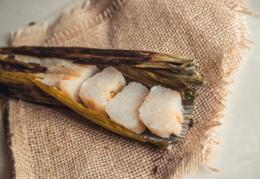 Brazilian traditional dessert. Bolo de tapioca (mane doido, pe de zumbi or pe de moleque nordestino similar to carim&atilde;, cassava cake). Brazilian cake made from tapioca flour, wrapped in banana leaves.