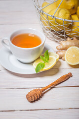 Ginger tea with mint, lemon and honey. Homemade warming tea for colds and flu.