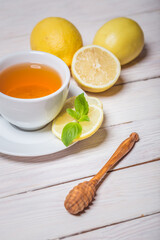 Ginger tea with mint, lemon and honey. Homemade warming tea for colds and flu.