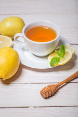 Ginger tea with mint, lemon and honey. Homemade warming tea for colds and flu.