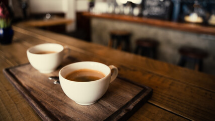 Fototapeta na wymiar close up of two freshly made coffees in big ceramic mugs 