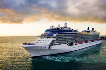 Big white modern cruiseship or cruise ship liner sail away departure from Key West, Florida during...