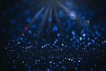 Abstract blue Christmas glowing background with shiny defocused lights, bokeh