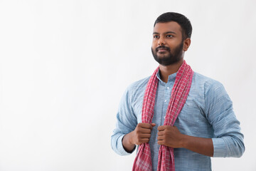 PORTRAIT OF A RURAL MAN STANDING AND LOOKING AWAY FROM CAMERA
