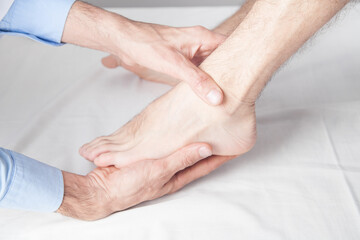 Fototapeta na wymiar Caucasian doctor massaging patient foot.