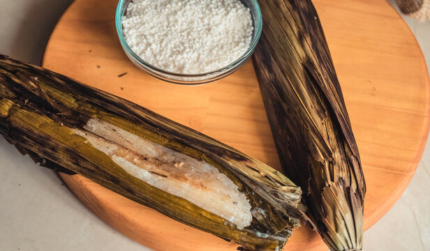 Brazilian traditional dessert. Bolo de tapioca (mane doido, pe de zumbi or pe de moleque nordestino similar to carim&atilde;, cassava cake). Brazilian cake made from tapioca flour, wrapped in banana leaves.