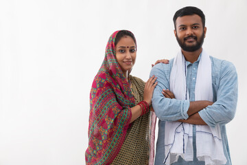 PORTRAIT OF A RURAL HUSBAND AND WIFE POSING IN FRONT OF CAMERA
