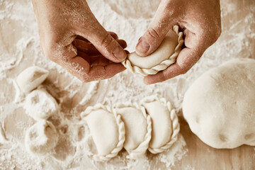 baker sculpts dumplings, baker's hands, dough, hands in flour, dumplings, handmade dumplings, ravioli