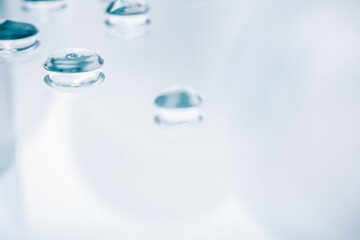 Drops of gel on a mirror surface. Background for the banner. Selective focus.