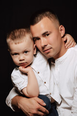 young Caucasian dad and boy son in white shirts