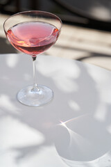 Red cocktail in martini glass with cherry. Exotic alcoholic cocktail