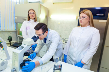 Obraz premium A group of scientists conducts research in a scientific laboratory using advanced technology. COVID-19. COVID Coronavirus