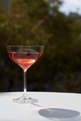 Red cocktail in martini glass with cherry. Exotic alcoholic cocktail