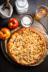Delicious apple pie with chocolate pieces and ingredients for Thanksgiving