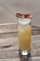 Refreshing cocktail glass with cucumber slice.