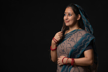 PORTRAIT OF A RURAL WOMAN SMILING AND LOOKING AWAY FROM CAMERA

