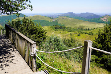 Fototapeta na wymiar wooden long walking pathway bridge in puy de dome french mountains volcano