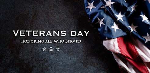 Happy Veterans Day concept. American flags against a dark stone  background. November 11.