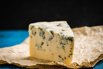 Tasty blue cheese on the rustic background. Selective focus. Shallow depth of field.
