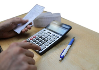 Man calculates bills using calculator.