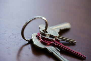Set of house keys on a keyring sitting on a table