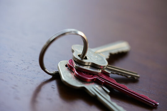 Set of house keys on a keyring sitting on a table