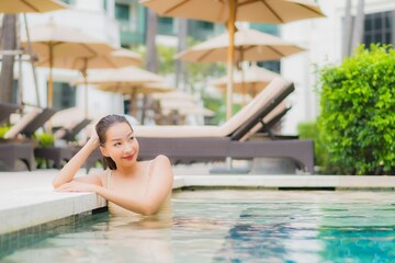 Portrait beautiful young asian woman relax smile around outdoor swimming pool