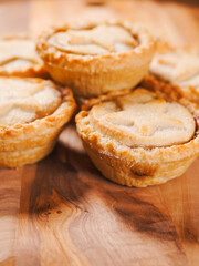.Traditional mince pie pastry on a wooden table. Popular Christmas season dessert. Close up